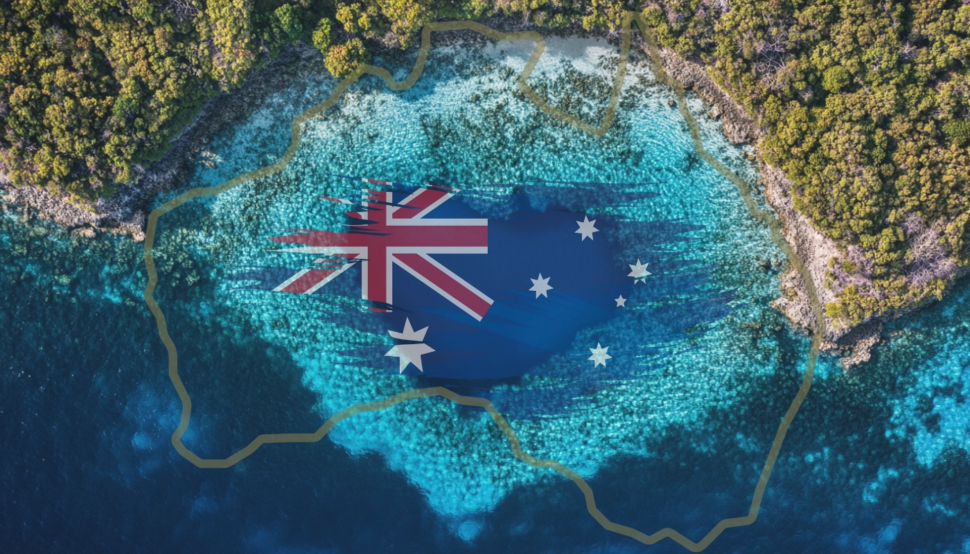 Aerial view of Australia's coastline with the Australian flag overlaid on the ocean, bordered by lush greenery